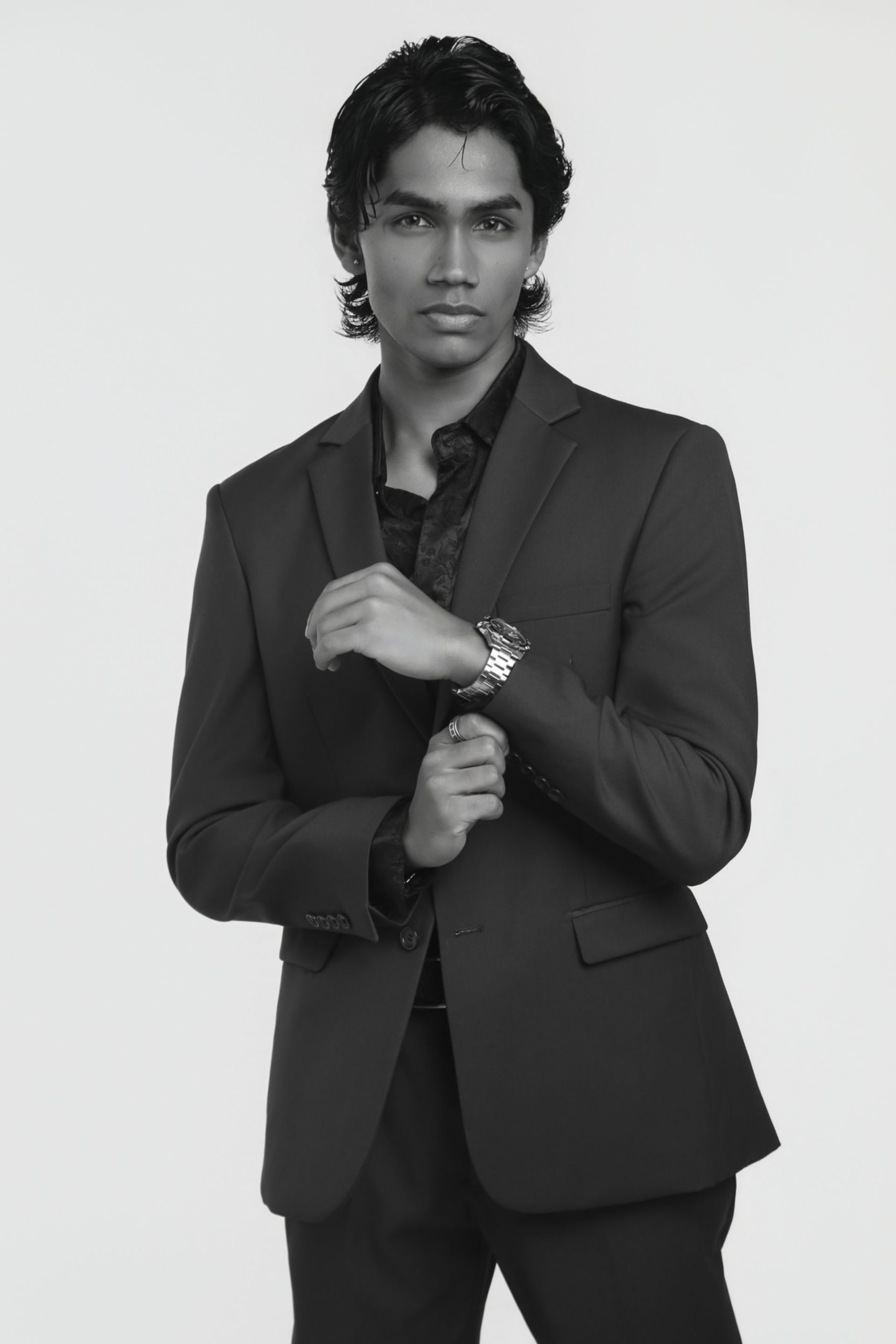 Black and white portrait of Shabs in a dark tailored suit